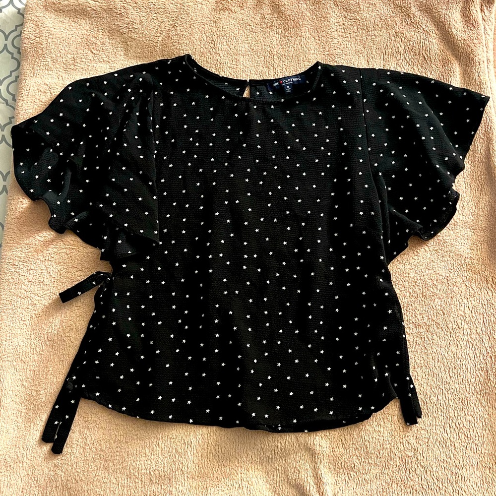 Black T-shirt with white stars, ruffle sleeves, and ties at sides